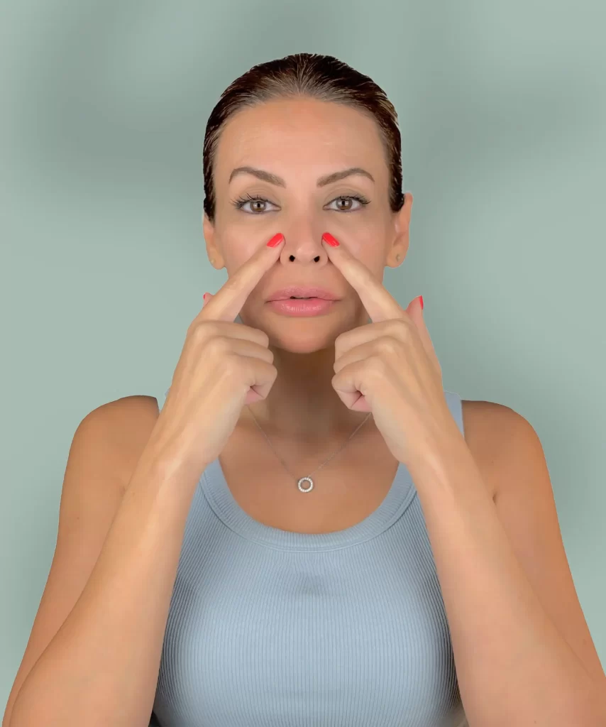 Artemis , certified face yoga coach, demonstrating natural exercises for wrinkle reduction and skin toning